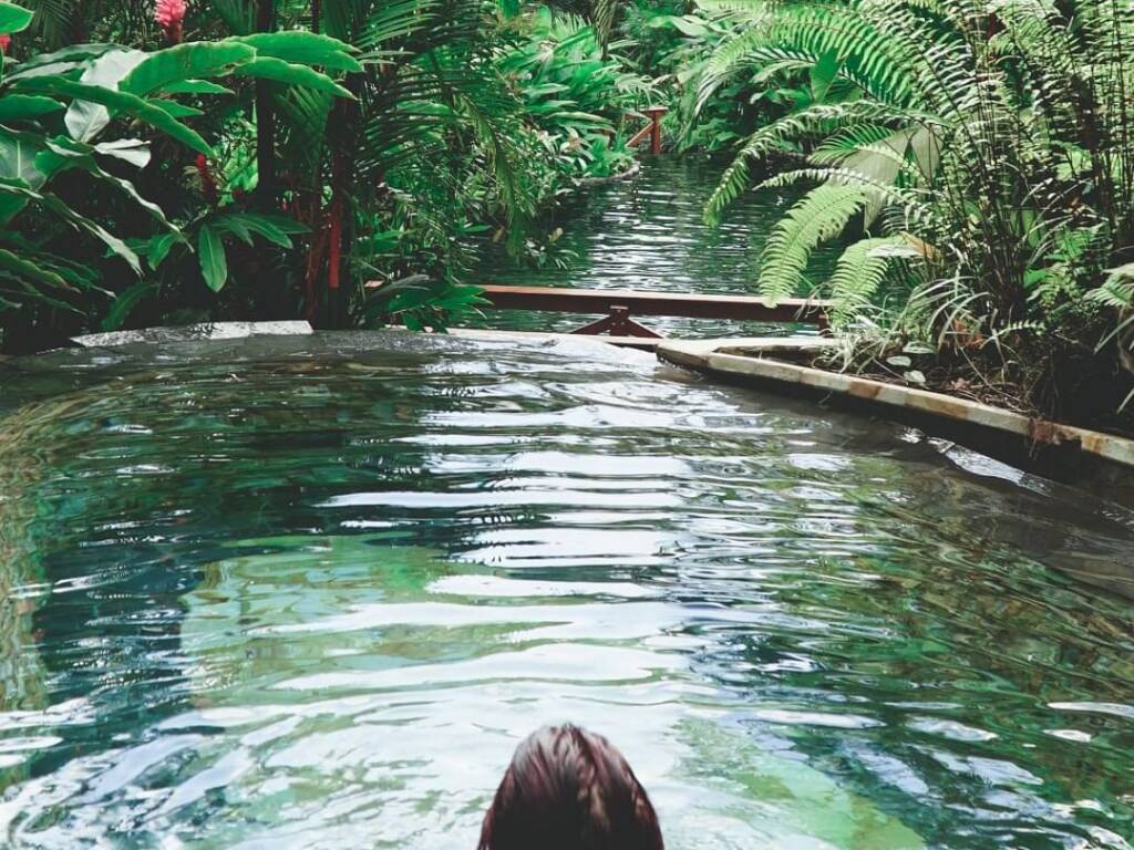 woman bathing in spring water at la fortuna